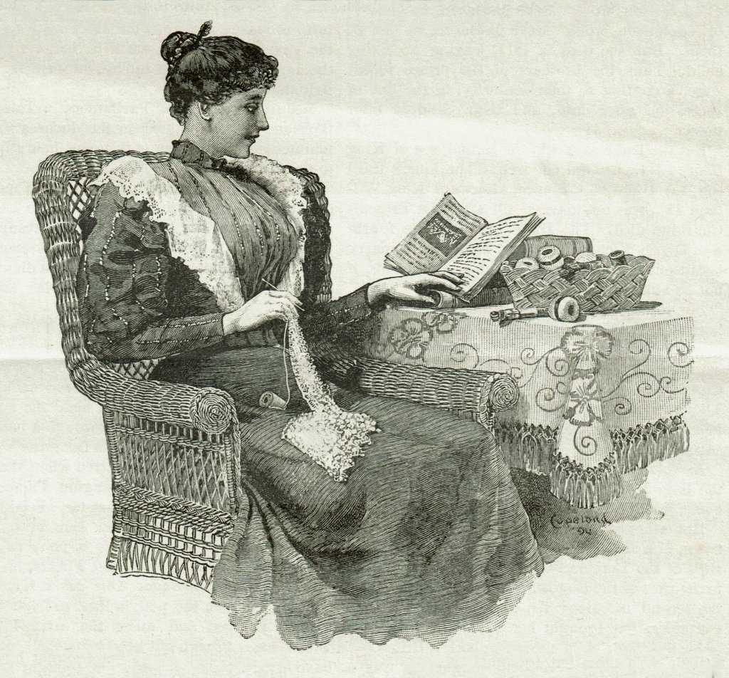 1894 Illustration of a woman making lace as she sits in a chair and refers to an instruction book open on a table beside her.