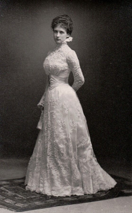 Photo of a young woman wearing a gown of lace.